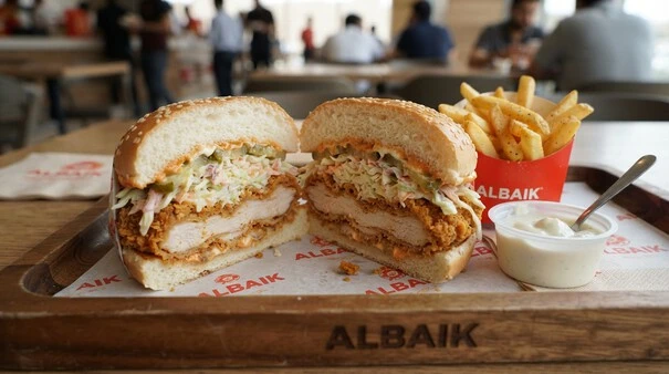 Popular Big Baik sandwich from Albaik Dammam menu with creamy sauce and fresh toppings.