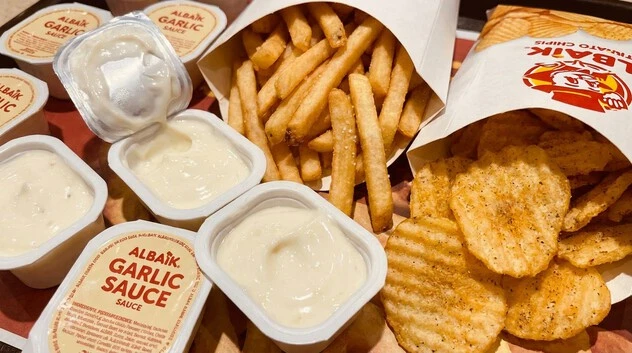 Must-try Albaik chips, fries with garlic sauce, coleslaw and other popular add-ons.